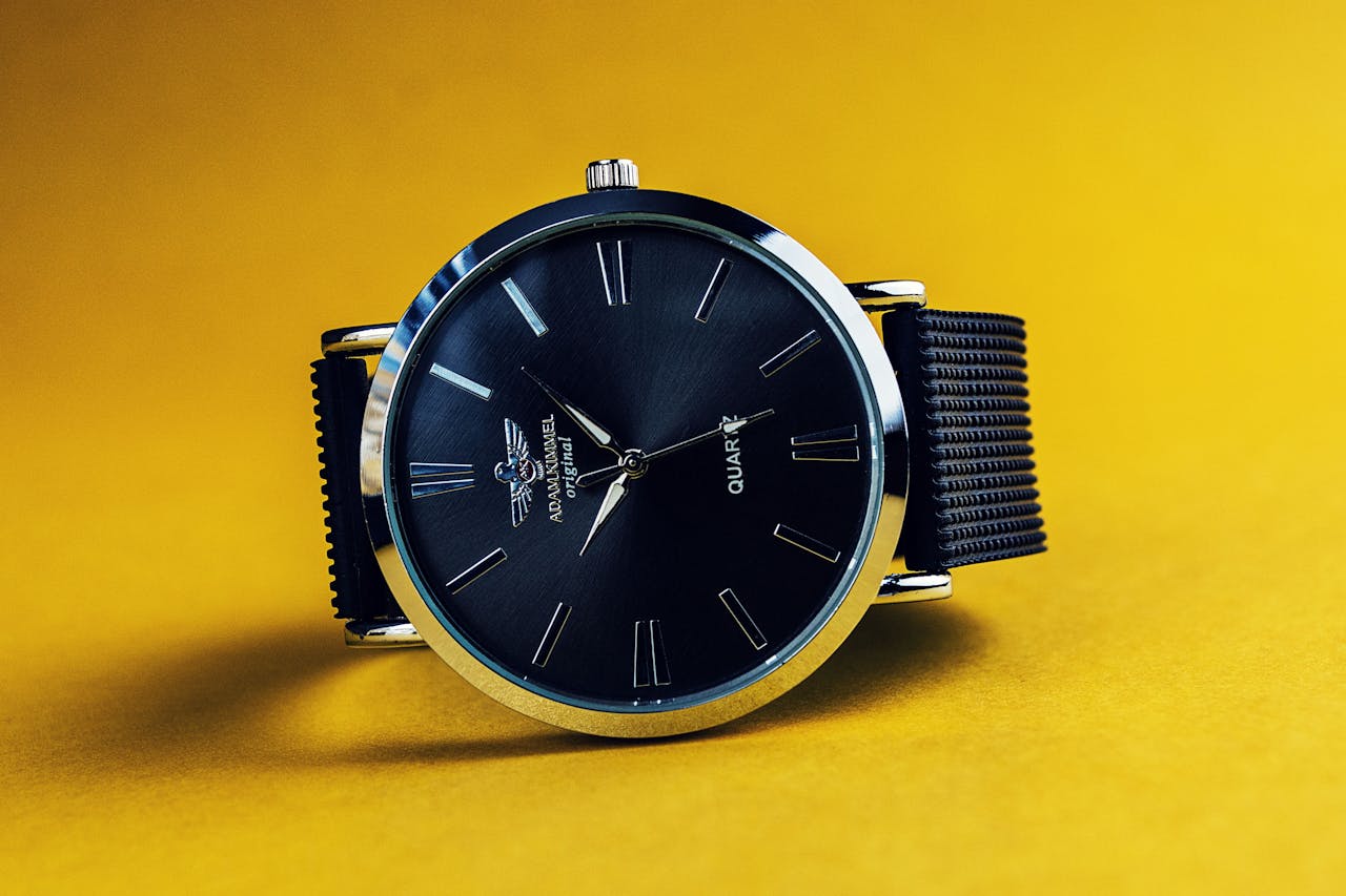 services-img Stylish black analog wristwatch with a black strap on a vibrant yellow background.
